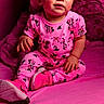 toddler, child, pink, pajamas, minnie_mouse, bed, pillow, clothing, footwear, sitting, indoors, person, cute, smiling, face, hair, home, cozy, soft, blanket