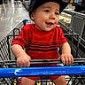 Elliott joined the competition — help win amazing prizes! baby, child, toddler, smiling, happy, shopping_cart, supermarket, grocery_store, red_shirt, baseball_cap, portrait, indoor, retail, aisle, shopping, cart_handle, sitting, infant, face, photography