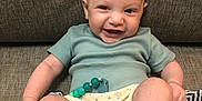 Kairo joined the competition — help win amazing prizes! baby, smiling, infant, couch, clothing, diaper, beads, happy, cute, face, feet, hand, sitting, indoors, textile, pattern, fabric, skin, person, portrait