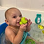 baby, bath, bathtub, blue, child, cute, face, green_toy, happy, infant, inside, plastic_toy, play, rubber_toy, sitting, smile, toy, water, wet, young_child