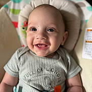 Kairo joined the competition — help win amazing prizes! baby, smiling, child, onesie, baby_chair, happy, infant, face, human, toddler, indoor, colorful, clothing, seat, cute, portrait, closeup, expression, skin, person