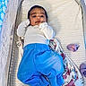 Ezra joined the competition — help win amazing prizes! baby, blanket, blue_pants, child, comfortable, crib, curious_expression, face, floral_pattern, footwear, hands, indoors, infant, lying_down, netting, person, purple_socks, striped_mattress, white_top, young_child