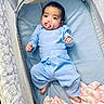baby, bed, blanket, blue_clothing, child, comfort, cozy, crib, cute, indoors, infant, mesh_sides, pacifier, peaceful, person, portrait, resting, sleeping_area, soft_fabric, toddler