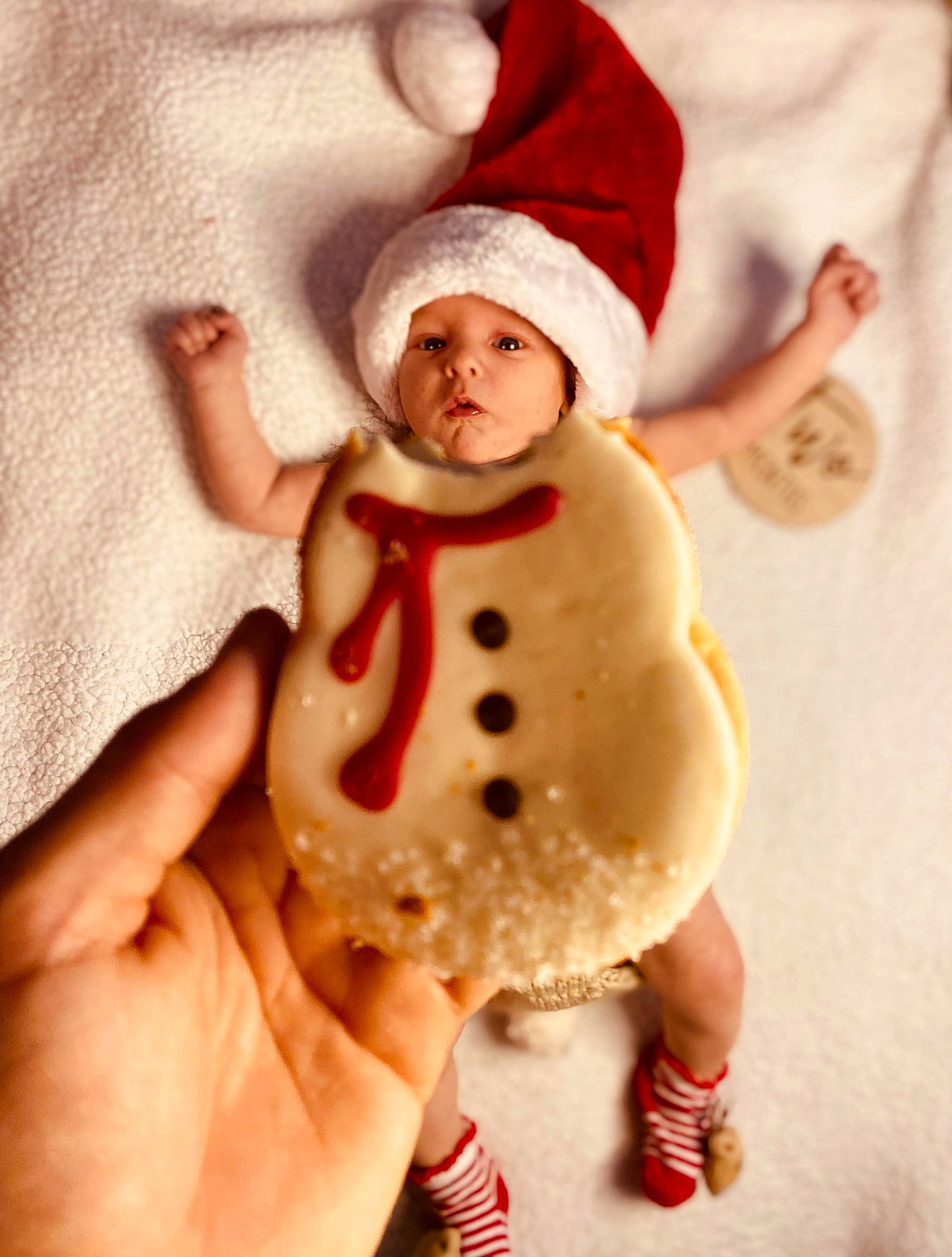 Judah is registered to the contest to win money with this photo: baby, baby_sleeping, baby_toddler_clothing, cap, child, christmas, costume_hat, fictional_character, finger, fur, gesture, hand, happy, headwear, holiday, knee, person, sleeve, snowman, thumb