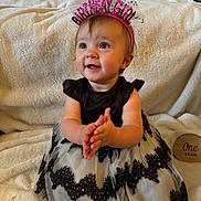 Eden is registered to the contest to win money with this photo: baby, birthday, birthday_girl, headband, clapping, dress, black_and_white, smiling, happy, child, one_year, celebration, indoor, blanket, portrait, cute, sitting, wooden_sign, face, person