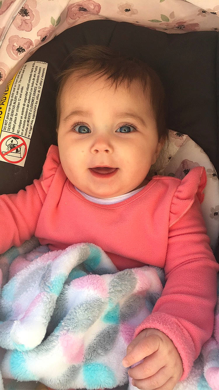 Annabella is registered to the contest to win money with this photo: baby, beauty, cheek, child, chin, eye, eyebrow, face, forehead, head, iris, lip, nose, person, pink, skin, smile, textile, toddler