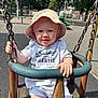 Arlo joined the competition — help win amazing prizes! baby, child, swing, playground, hat, sunhat, chains, smile, outdoor, daylight, clothing, happy, person, infant, park, seat, play, fun, summer, casual