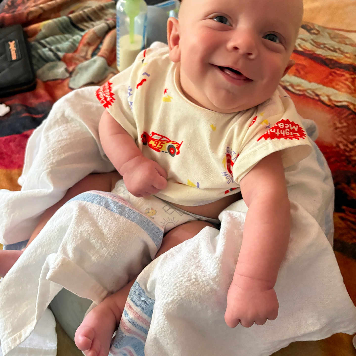 Braydon joined the competition — help win amazing prizes! baby, bed, blanket, bottle, child, clothing, cute, diaper, fabric, face, foot, hand, happy, indoor, infant, newborn, person, portrait, skin, smiling