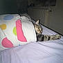cat, tabby, blanket, bed, sleeping, stretching, indoor, polka_dot, paw, cozy, feline, resting, comfort, domestic, cute, striped, nighttime, relaxation, soft, warm