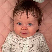 Taylor joined the competition — help win amazing prizes! baby, infant, child, face, eyes, hair, onesie, animal_print, blanket, pink_background, quilted, mobile, toy, cheeks, smile, portrait, lying_down, close_up, nursery, adorable