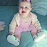 Josie joined the competition — help win amazing prizes! baby, child, infant, smiling, sitting, portrait, pink_outfit, headband, bow, shoes, bed, blanket, pillows, plush_toy, indoors, bedroom, cozy, happy, front_facing, daylight