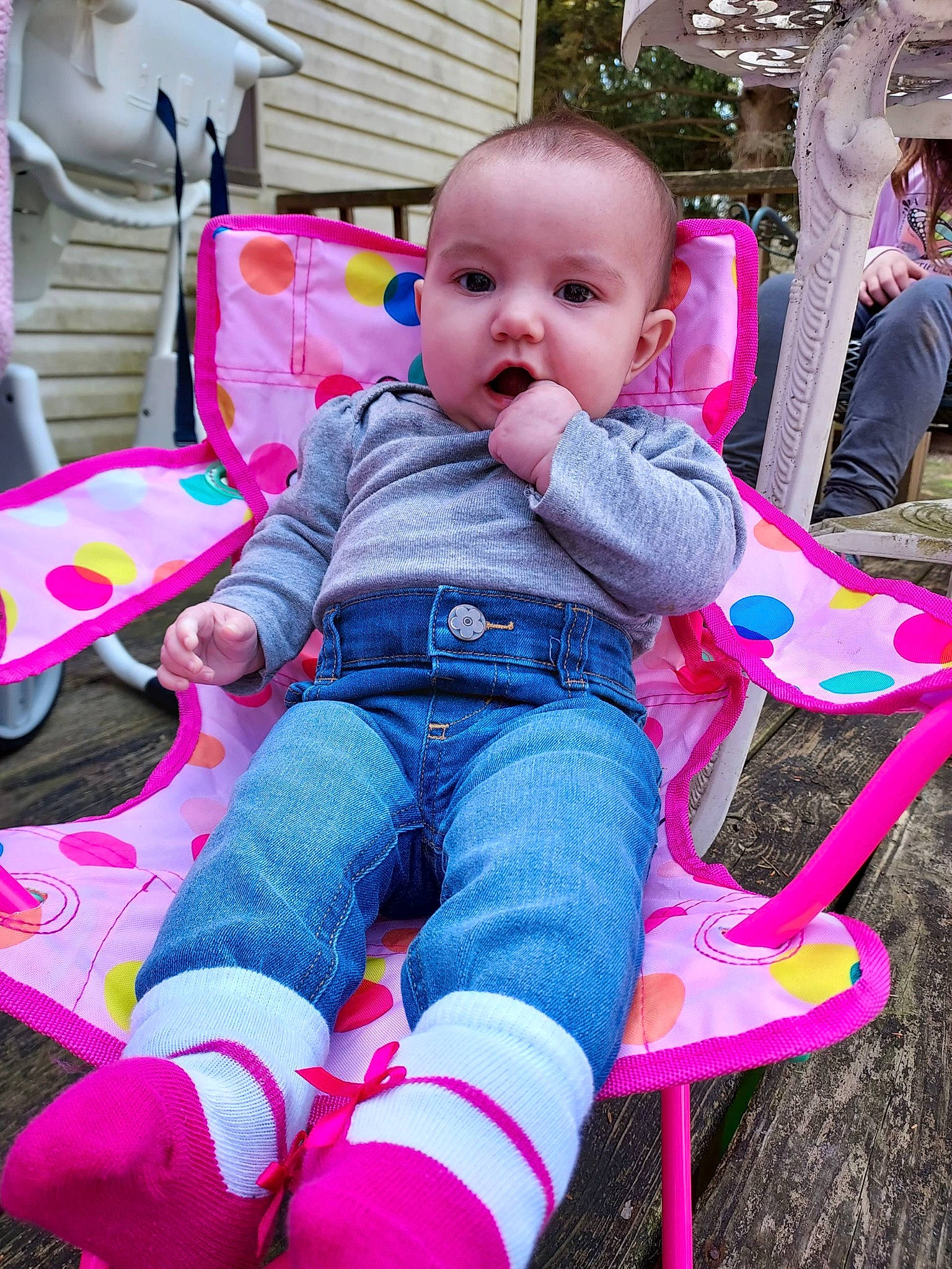 Paisleigh is registered to the contest to win money with this photo: baby, baby_toddler_clothing, cheek, child, eye, face, fun, grass, happy, leisure, magenta, person, pink, play, public_space, red, sitting, skin, toddler, tree