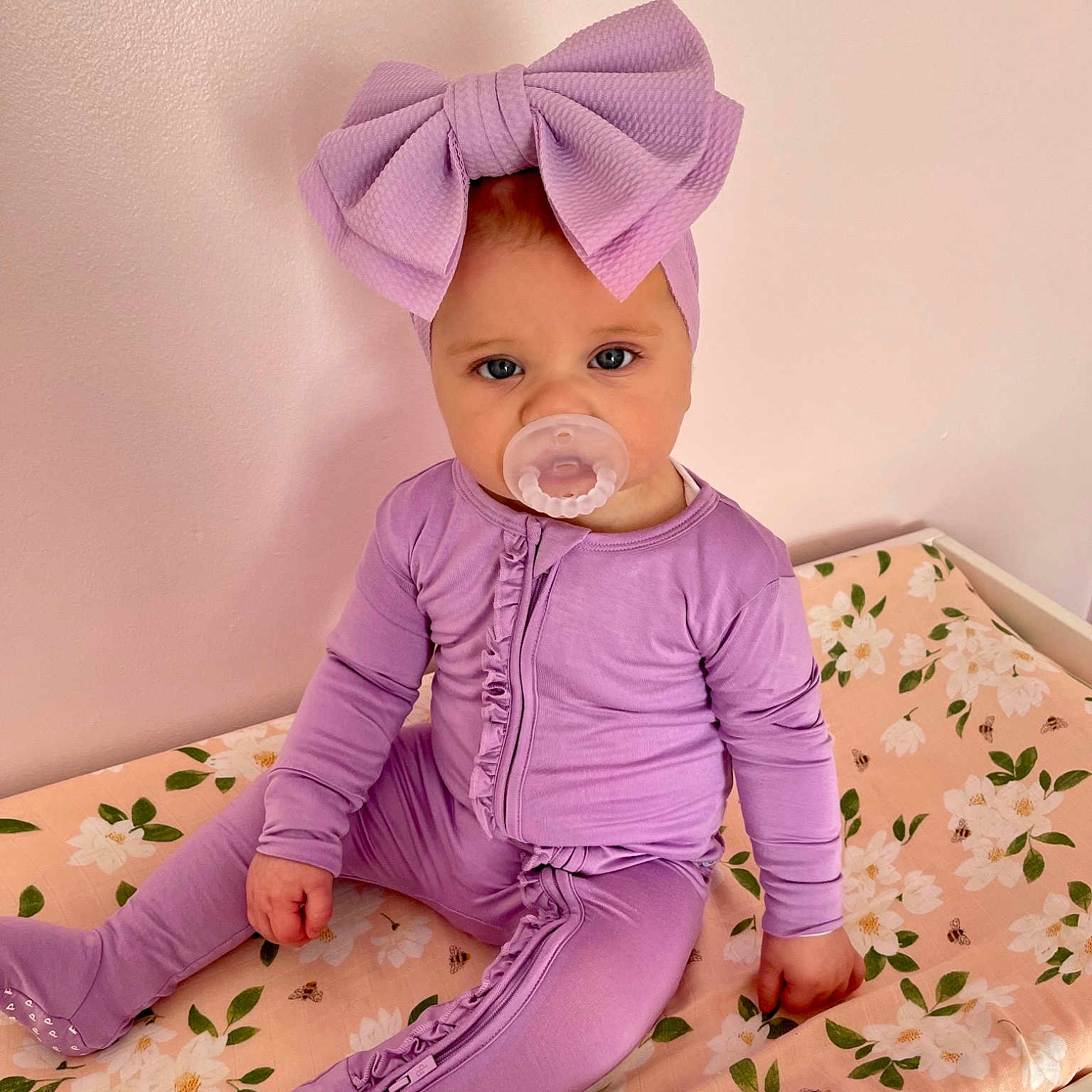 Gemma is registered to the contest to win money with this photo: baby, baby_toddler_clothing, child, clothing, face, happy, head, human_body, magenta, pattern, pink, product, purple, room, skin, sleeve, sock, textile, toddler, violet