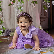 Kimberly joined the competition — help win amazing prizes! baby, child, dress, purple, bow, flower, crawling, smile, headband, portrait, cute, indoor, decor, curly_hair, jewelry, person, happy, toddler, soft_lighting, floor