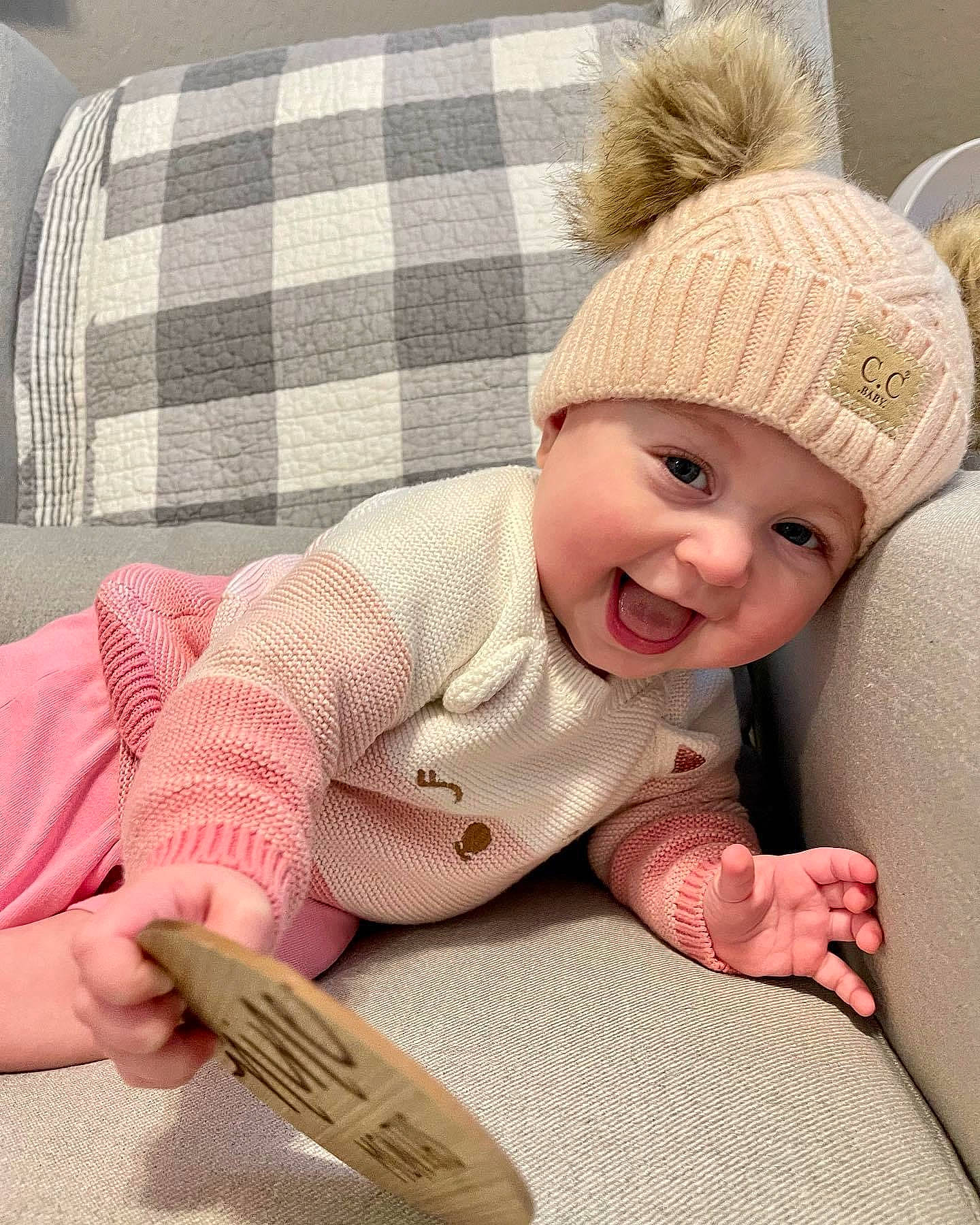Gianna joined the competition — help win amazing prizes! baby, baby_toddler_clothing, cap, child, comfort, eye, face, finger, flooring, happy, headwear, lip, pattern, person, plaid, skin, sleeve, smile, tartan, textile