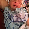 Sevyn joined the competition — help win amazing prizes! newborn, baby, sleeping, infant, hat, onesie, striped_clothing, bottle, blanket, cozy, peaceful, cradled, indoor, soft_lighting, closeup, human, child, cute, resting, toddler