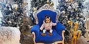Layla participe au concours pour gagner de l'argent avec cette photo : child, toddler, chair, blue_chair, pink_jacket, christmas_tree, ornaments, nutcracker, eiffel_tower_model, holiday_decor, frosted_trees, indoor, floor, wooden_floor, festive, winter_clothing, person, decorations, toy, seat