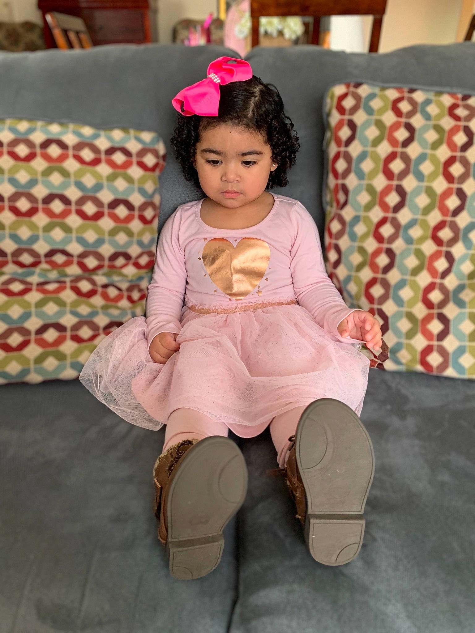 Mia is registered to the contest to win money with this photo: child, fawn, footwear, leg, person, pink, shoe, sitting, skin, toddler