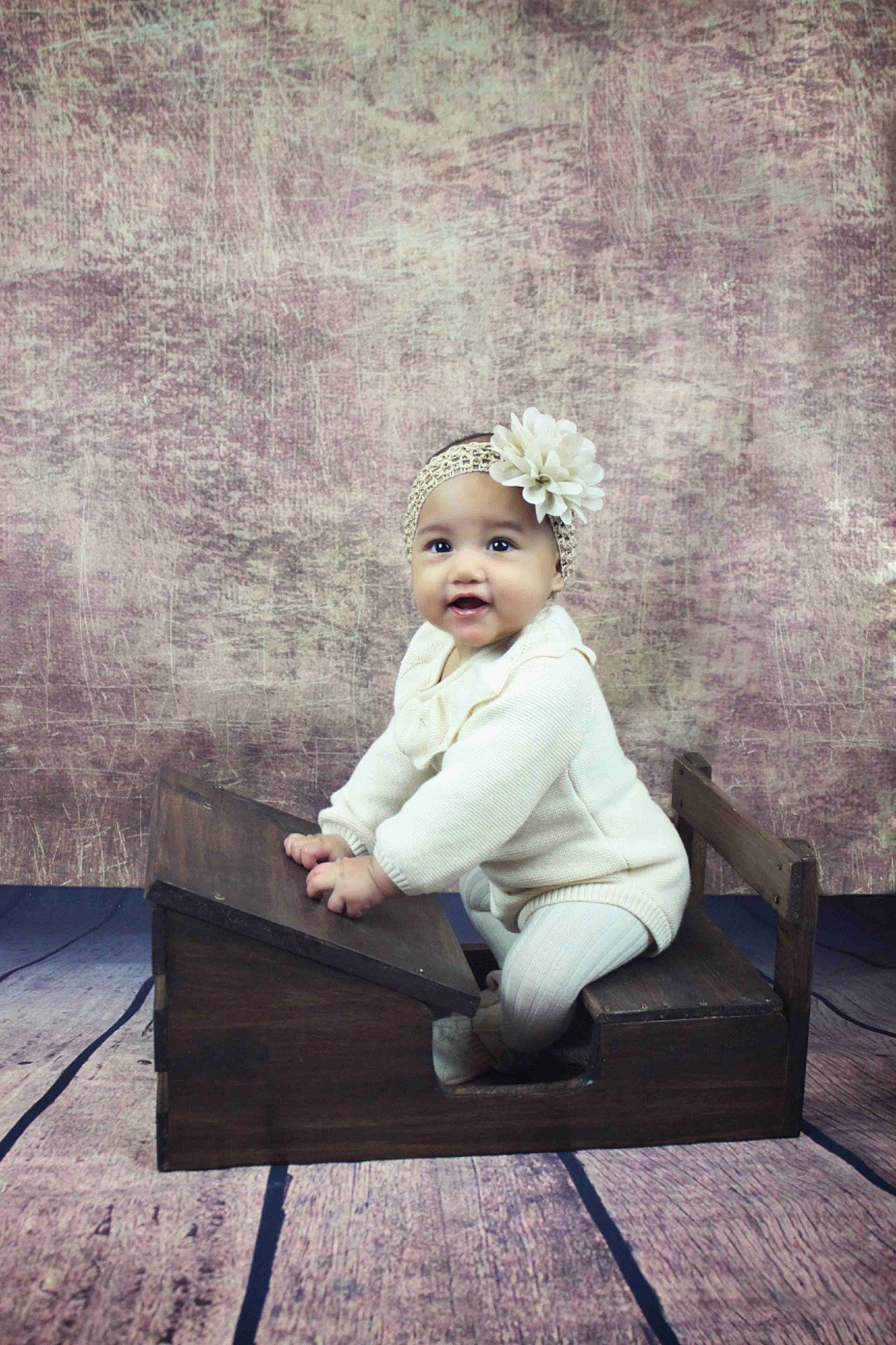 Vaheana participe au concours pour gagner de l'argent avec cette photo : baby, baby_toddler_clothing, bench, child, comfort, fashion_accessory, flash_photography, flooring, happy, headband, headpiece, headwear, jewellery, monochrome, person, portrait, portrait_photography, sitting, tints_and_shades, toddler