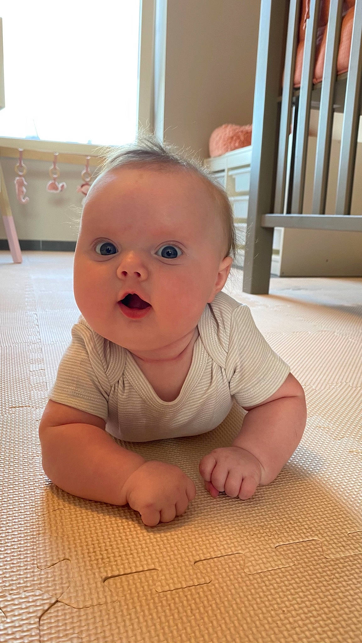 Billie participe au concours pour gagner de l'argent avec cette photo : baby, baby_crawling, baby_toddler_clothing, cheek, chin, crawling, eye, eyebrow, face, floor, flooring, hardwood, head, iris, mouth, nose, person, product, skin, surprise