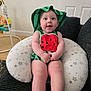 baby, child, infant, smile, hat, watermelon_outfit, cushion, star_pattern, indoor, furniture, door, happy, person, seated, cute, skin, legs, hands, expression, room