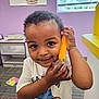 Isaiah joined the competition — help win amazing prizes! toddler, child, toy, indoor, playroom, birthday_board, window, curly_hair, white_shirt, carpet, smile, face, hand, wall, furniture, colorful, person, young_child, portrait, cute