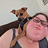 person, dog, glasses, indoor, shoulder, casual, tank_top, brown_dog, pet, relaxed, couch, wall_decor, closeup, portrait, companion, animal, friendship, comfortable, curious, casual_wear