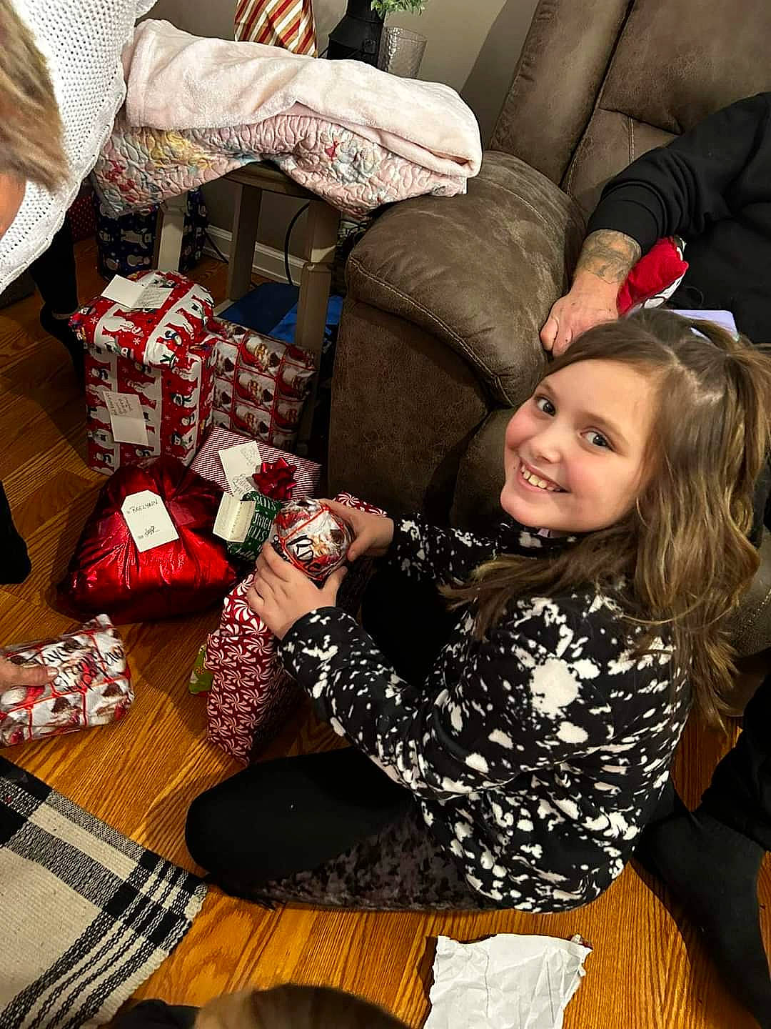 Raelynn is registered to the contest to win money with this photo: carmine, christmas, christmas_eve, comfort, couch, event, fashion, fashion_accessory, fun, gift_wrapping, happy, holiday, human_leg, joy, lap, leisure, pattern, person, sitting, smile