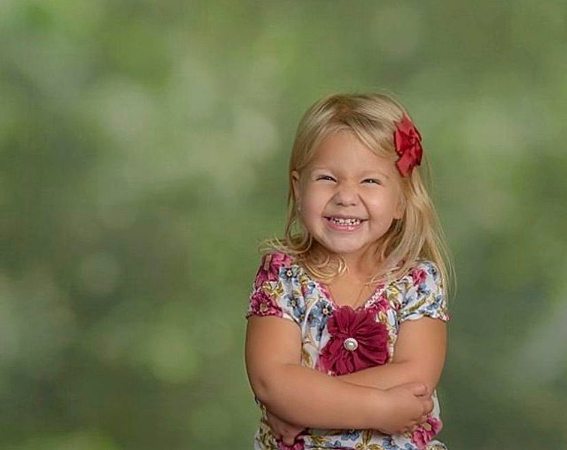 Kayla is registered to the contest to win money with this photo: blond, child, dress, event, flash_photography, fun, grass, grassland, happy, joy, landscape, laugh, magenta, meadow, people_in_nature, person, plant, prairie, smile, toddler