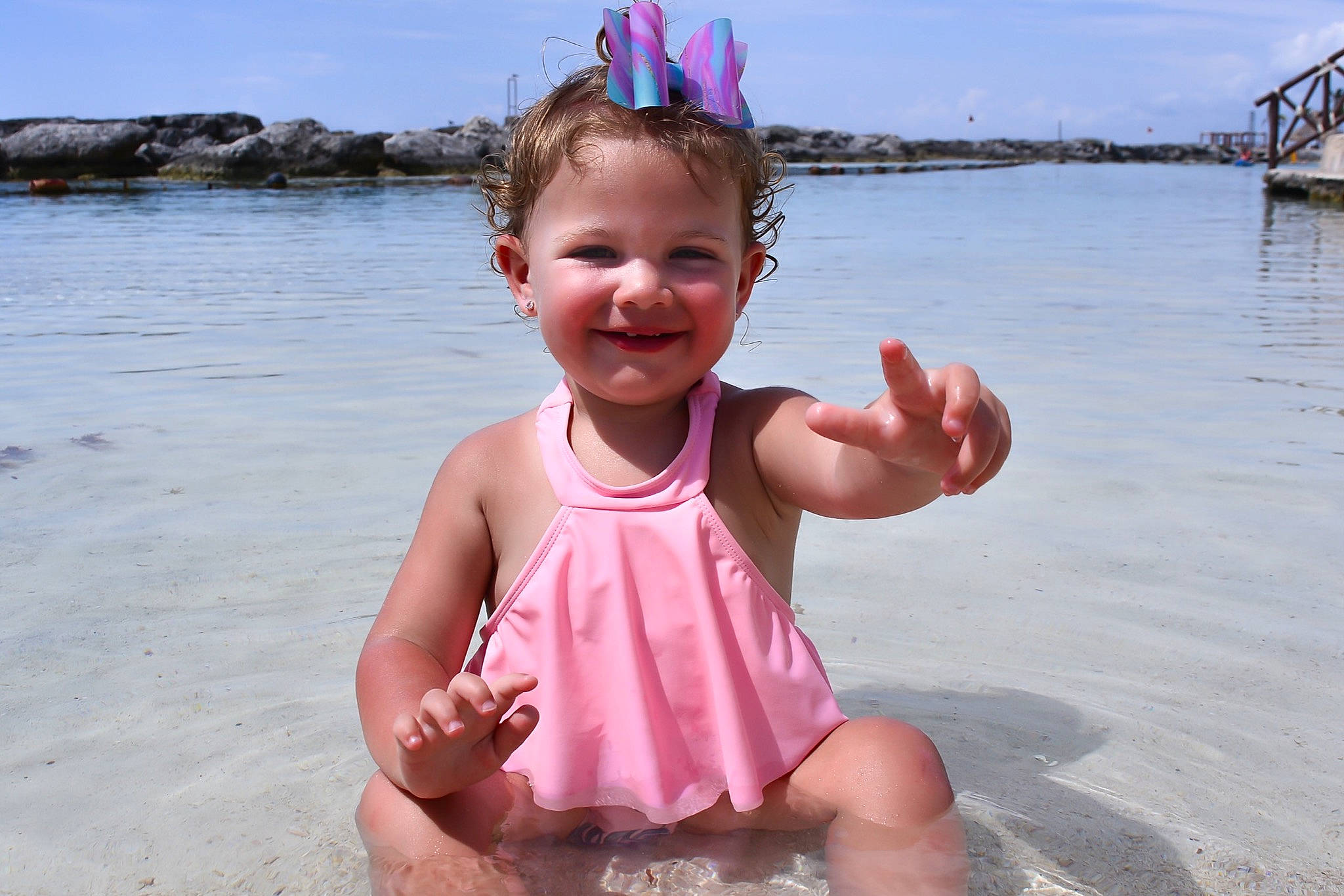 Alexa joined the competition — help win amazing prizes! baby_toddler_clothing, beach, blue, fun, happy, head, holiday, joy, lake, leisure, people_on_beach, person, personal_protective_equipment, pink, recreation, sand, sky, smile, summer, toddler