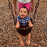 Truen joined the competition — help win amazing prizes! baby, child, swing, playground, wood_chips, grass, person, holding, blue_shirt, pink_shorts, happy, smiling, outdoor, summer, fun, park, feet, hands, cute, hair