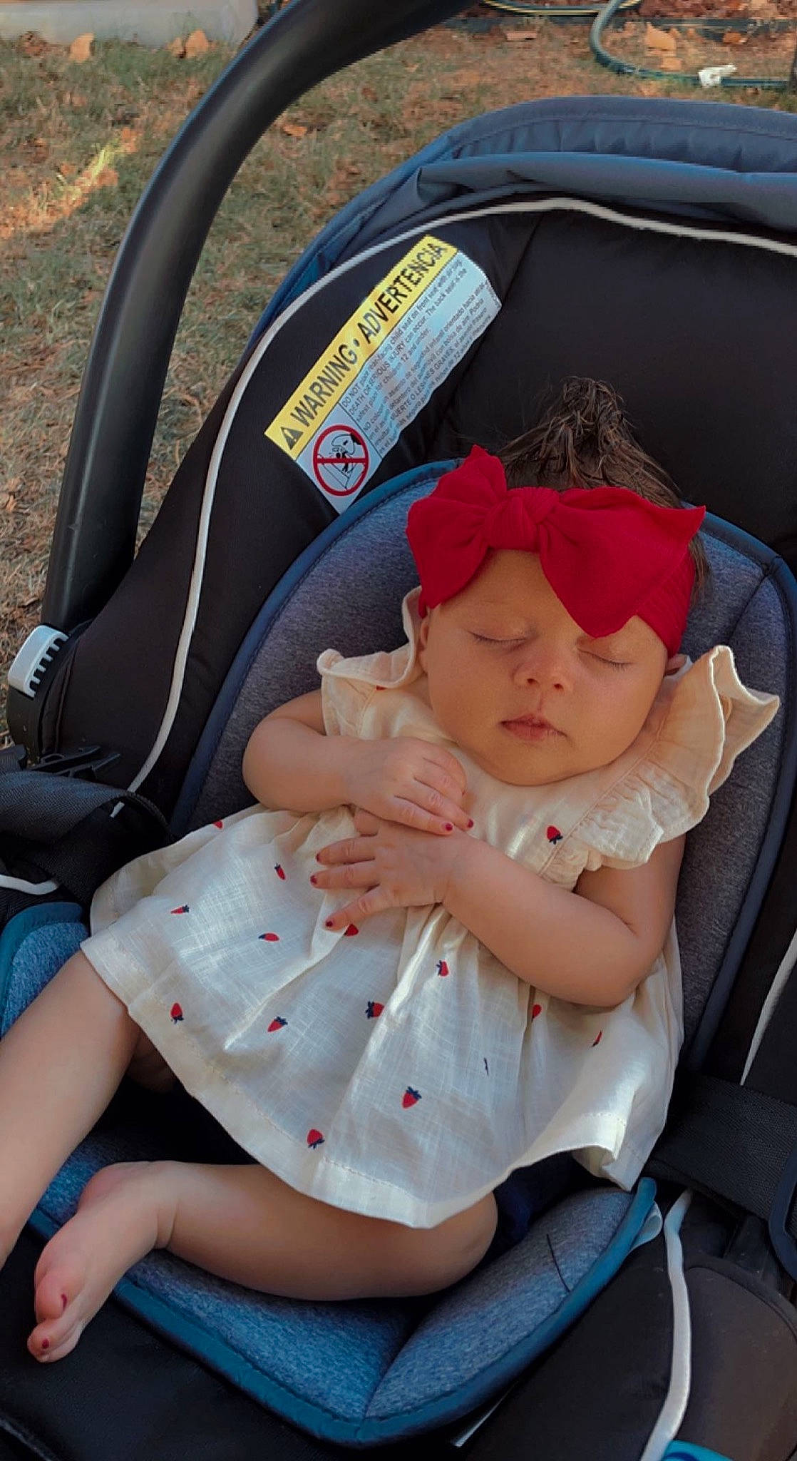 Saige is registered to the contest to win money with this photo: auto_part, automotive_design, baby, baby_carriage, baby_products, baby_toddler_clothing, cap, car_seat, child, comfort, family_car, grass, hat, headwear, motor_vehicle, person, plant, sitting, sun_hat, toddler