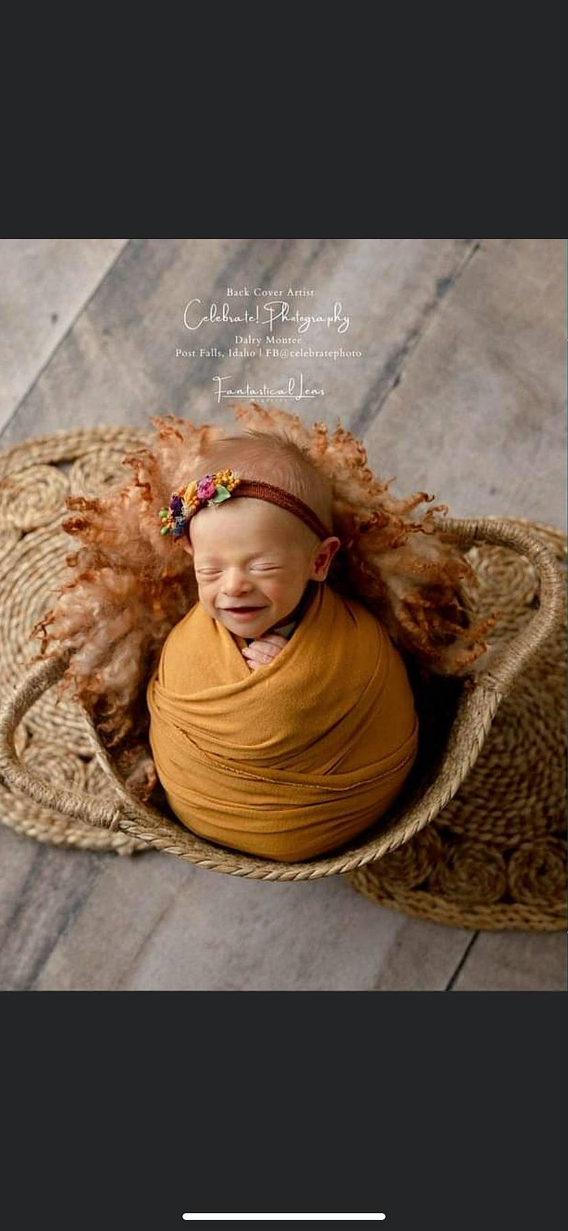 Elsie is registered to the contest to win money with this photo: baby, cap, child, font, fun, fur, grass, happy, hat, head, headgear, people_in_nature, person, photo_caption, portrait_photography, sitting, smile, soil, toddler, wood