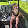 Joshua is registered to the contest to win money with this photo: baby, child, stroller, harness, outdoor, grass, greenery, sunlight, happy, smiling, seat, residential, house, backyard, person, infant, summer, daylight, nature, playtime