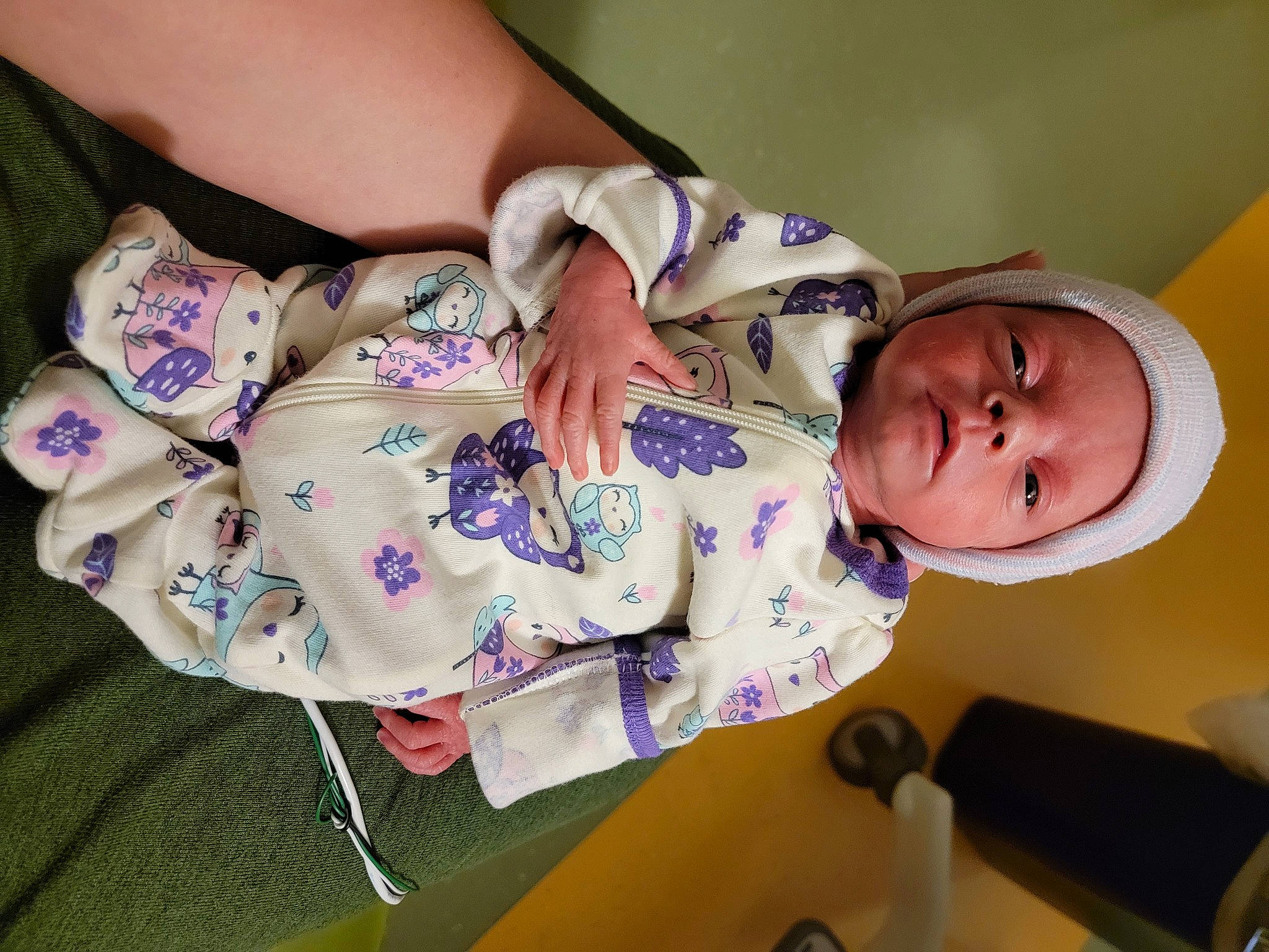 Addie is registered to the contest to win money with this photo: baby, baby_products, baby_toddler_clothing, cheek, child, comfort, dress, finger, hand, happy, human_body, nail, pattern, person, product, purple, room, skin, sleeve, toddler