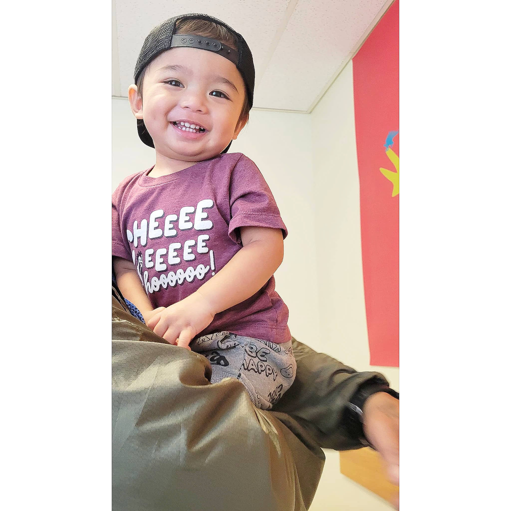 Kade is registered to the contest to win money with this photo: baby, baby_toddler_clothing, cap, child, cool, elbow, font, happy, headwear, joy, magenta, pattern, person, pink, portrait_photography, shorts, sitting, sleeve, smile, t_shirt