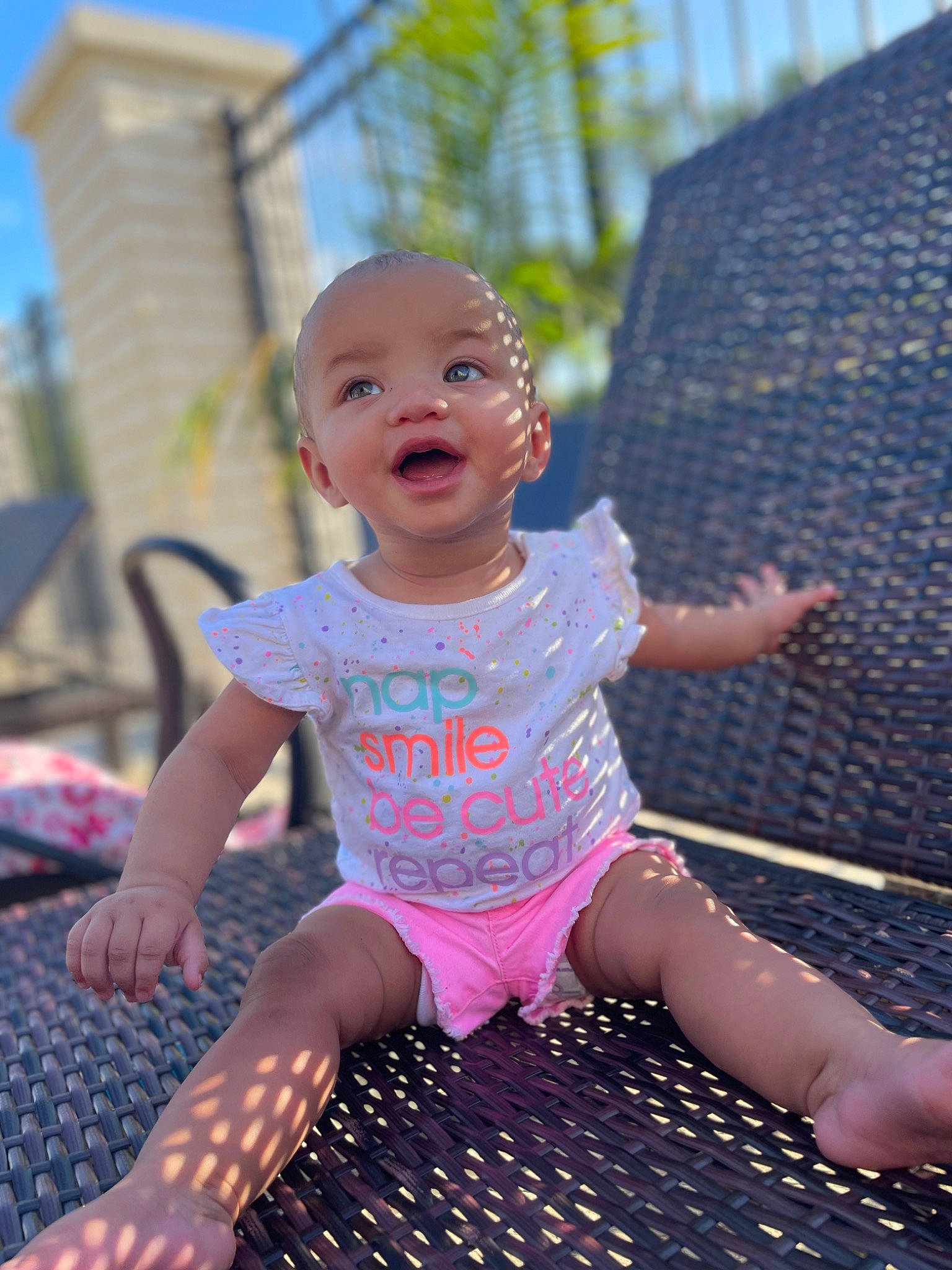 Yelaya is registered to the contest to win money with this photo: baby, baby_toddler_clothing, child, flooring, fun, grass, happy, human_leg, leisure, magenta, pattern, person, pink, purple, recreation, sitting, sky, smile, t_shirt, thigh