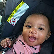 Taylen is registered to the contest to win money with this photo: baby, child, car_seat, smiling, happy, infant, seatbelt, pink_clothing, portrait, cute, indoors, safety, car_interior, face, person, young_child, closeup, expression, joy, baby_girl