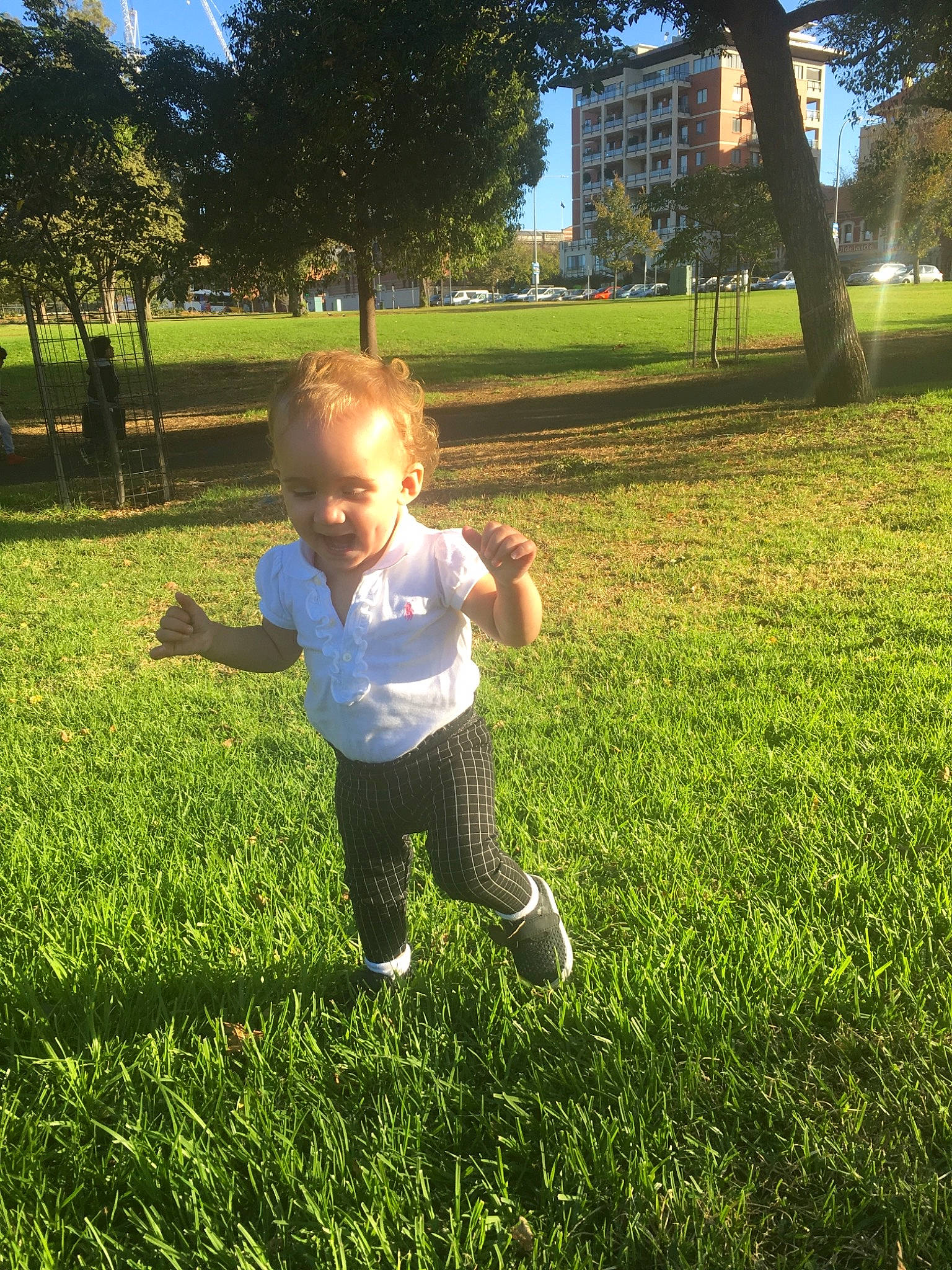 Artemis is registered to the contest to win money with this photo: child, fun, grass, grass_family, green, happy, lawn, leaf, light, meadow, park, people_in_nature, person, plant, play, sky, summer, sunlight, toddler, tree