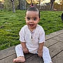 baby, child, smiling, outdoor, grass, wooden_deck, sunset, greenery, person, happy, cute, sitting, playground, tree, nature, barefoot, clothing, face, young, daylight