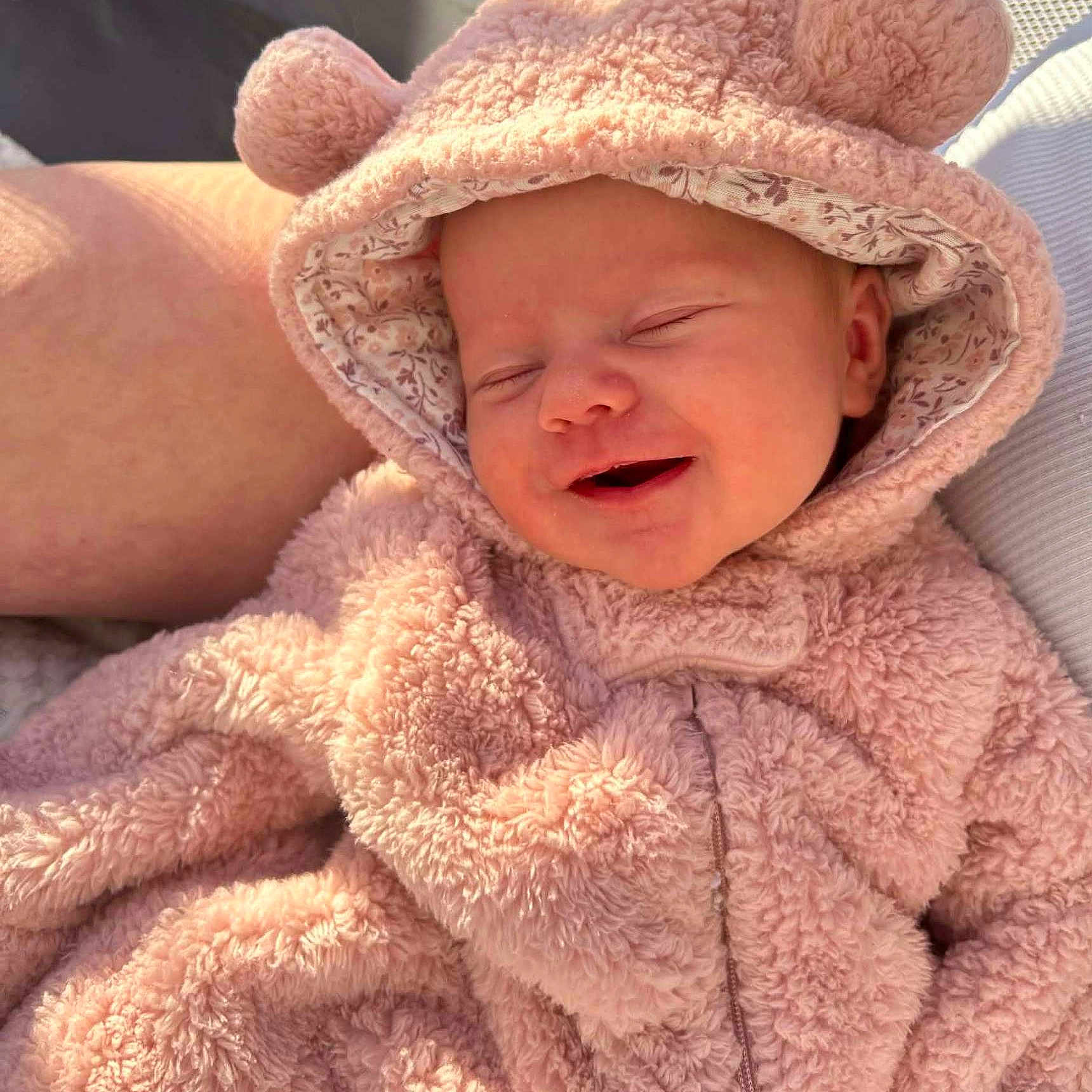 Raelynne joined the competition — help win amazing prizes! baby, child, smiling, sleeping, pink, onesie, hood, fluffy, soft, cute, face, infant, cozy, warm, sunlight, portrait, resting, happy, closeup, person