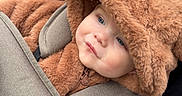 Zachary joined the competition — help win amazing prizes! baby, child, stroller, fuzzy_clothing, hood, bear_ears, cute, outdoor, bundle_up, seatbelt, cozy, face, infant, warm_clothing, portrait, expression, child_in_stroller, winter_wear, soft_texture, curious_look