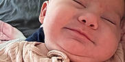 Lainey is registered to the contest to win money with this photo: baby, smile, face, infant, clothing, pink, zipper, skin, person, closeup, head, cute, cheeks, sleepy, soft, cozy, bed, blanket, rest, portrait