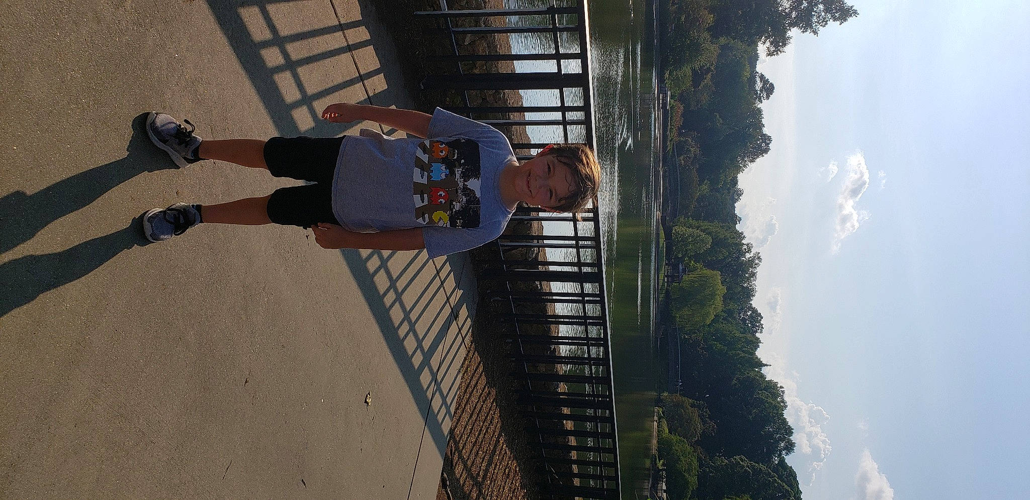 Wyatt is registered to the contest to win money with this photo: building, cloud, facade, fun, human_leg, jeans, joy, leisure, line, outdoor_shoe, pedestrian, person, plant, reflection, shadow, sidewalk, sky, snapshot, thigh, tree