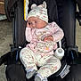 baby, sleeping, car_seat, pacifier, baby_bottle, hat, pajamas, infant, cute, cozy, child, resting, clothing, footwear, pink, white, patterned, outdoor, concrete, black