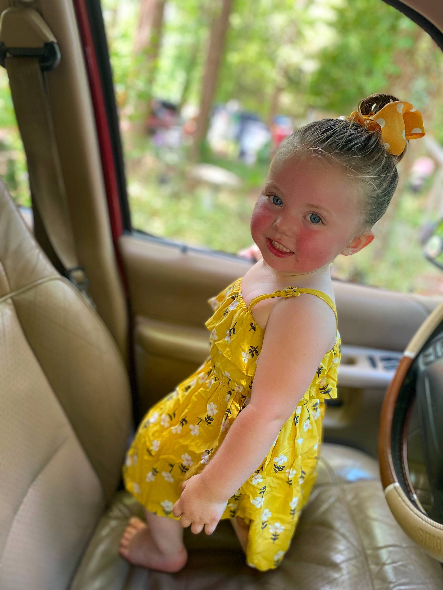 Jazmynn is registered to the contest to win money with this photo: auto_part, automotive_design, automotive_exterior, baby_toddler_clothing, car, dress, eye, grass, happy, joy, leaf, leisure, morning, motor_vehicle, person, plant, smile, steering_wheel, toddler, tree