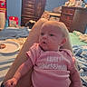 baby, bed, blanket, candid, casual, child, clutter, diapers, dresser, furniture, homedecor, indoor, infant, legs, light, person, pink_onesie, resting, room, television