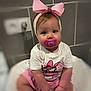 Shelby participe au concours pour gagner de l'argent avec cette photo : baby, child, pacifier, pink_bow, headband, white_shirt, pink_shorts, sitting, indoor, tile_wall, cute, portrait, face, hands, blue_eyes, infant, plush_chair, clothing, person, young_child
