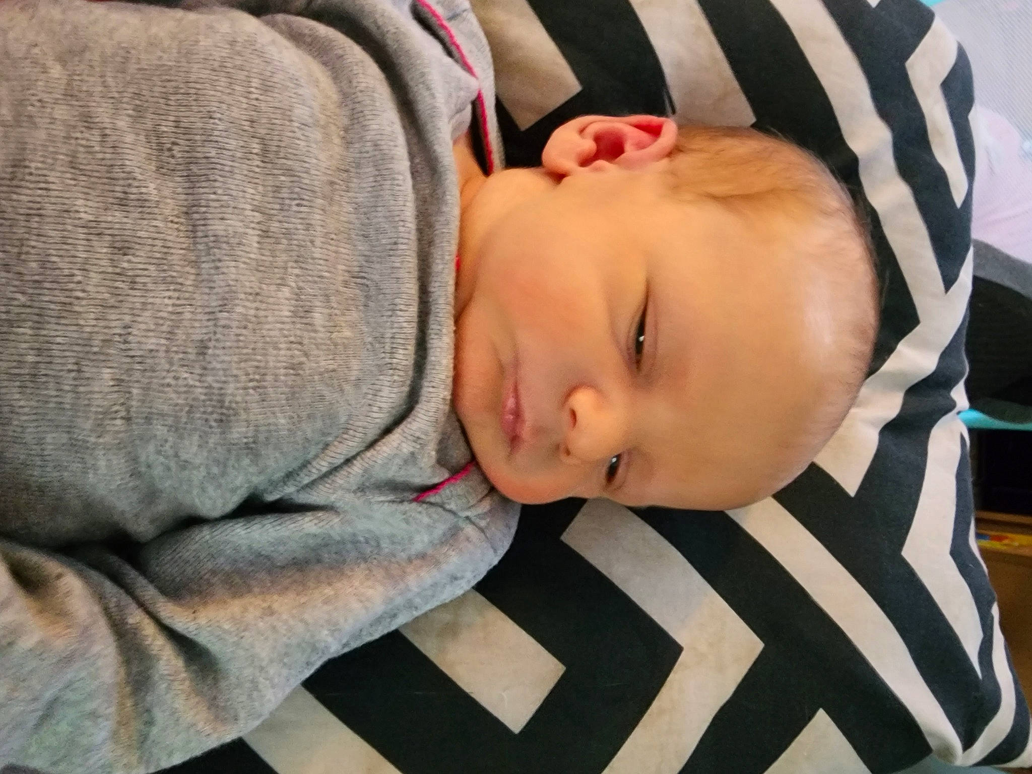 Damian is registered to the contest to win money with this photo: baby, baby_toddler_clothing, cheek, child, comfort, flooring, linens, pattern, person, portrait_photography, sitting, sleep, sleeve, toddler, wood