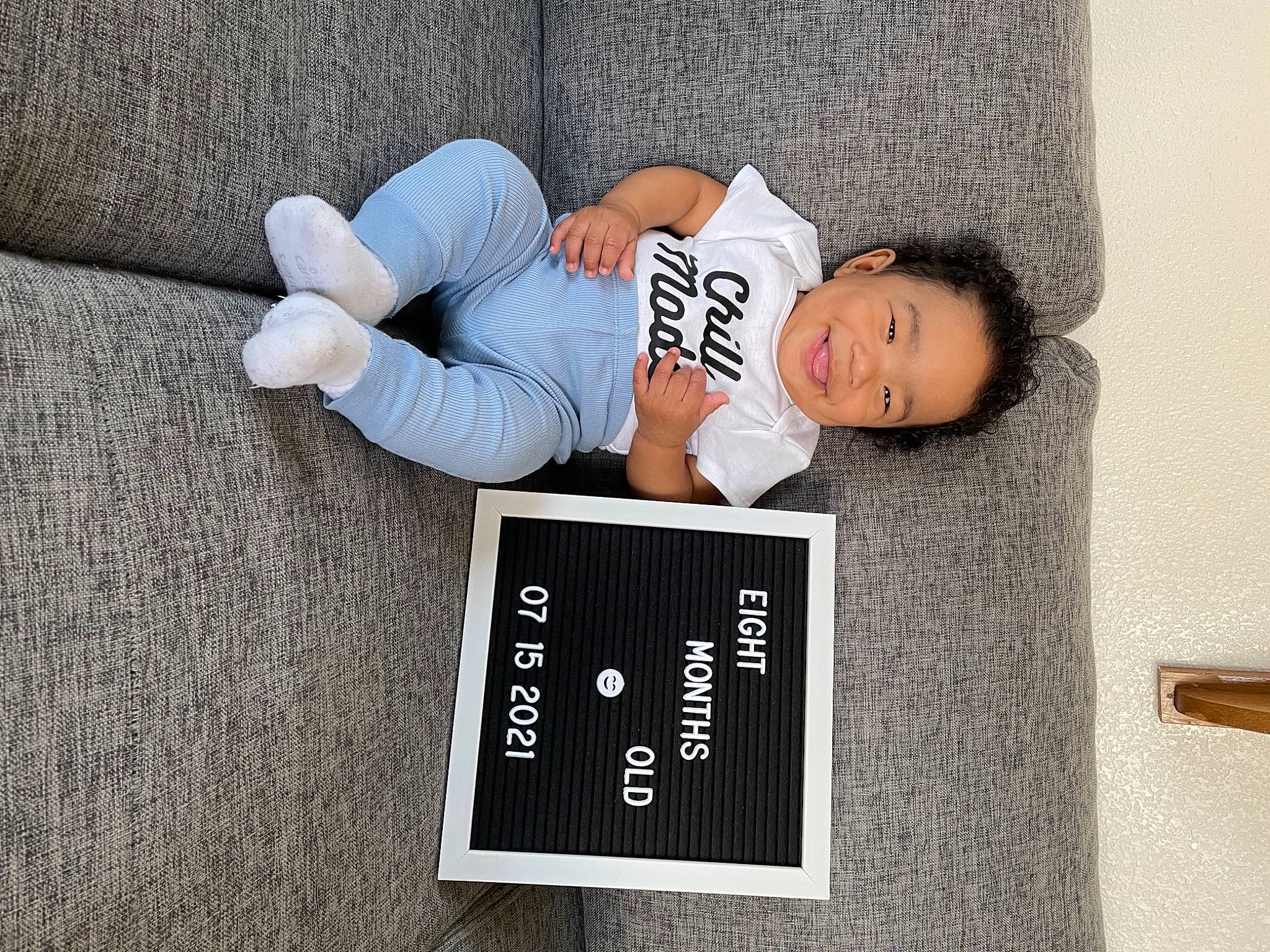 Kenzo joined the competition — help win amazing prizes! child, comfort, couch, denim, elbow, flooring, font, gesture, grey, happy, human_leg, joy, knee, linens, person, room, sitting, sleeve, smile, t_shirt
